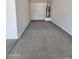 Clean and spacious two-car garage with overhead storage at 10541 W Sonrisas St, Tolleson, AZ 85353