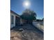 Spacious backyard with gravel and a large tree, offering ample outdoor space at 10854 W Monte Vista Rd, Avondale, AZ 85392