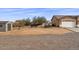 Backyard view, showcasing a storage shed and partially fenced area at 12121 S 214Th Ave, Buckeye, AZ 85326