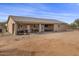 House back yard with covered patio, grill, and ample space at 12121 S 214Th Ave, Buckeye, AZ 85326