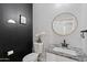 Modern bathroom with granite countertop, white cabinets, and black accents at 12121 S 214Th Ave, Buckeye, AZ 85326