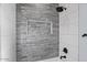 Modern bathroom with gray stone and white tile shower surround at 12121 S 214Th Ave, Buckeye, AZ 85326