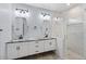 Double vanity bathroom with granite countertops and a large shower at 12121 S 214Th Ave, Buckeye, AZ 85326