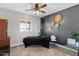 Versatile bedroom with a dark accent wall and built-in shelving at 12121 S 214Th Ave, Buckeye, AZ 85326