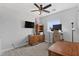 Bright bedroom featuring a desk, built-in shelving, and ceiling fan at 12121 S 214Th Ave, Buckeye, AZ 85326