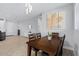 Bright dining room with wooden table and chairs, hardwood floors, and modern light fixture at 12121 S 214Th Ave, Buckeye, AZ 85326