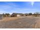 House exterior, showing a large yard, storage shed, and desert landscape at 12121 S 214Th Ave, Buckeye, AZ 85326