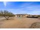 View of a single-story house with a large yard and desert landscaping at 12121 S 214Th Dr, Buckeye, AZ 85326