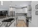 Modern kitchen with granite countertops, stainless steel appliances, and white cabinetry at 12121 S 214Th Ave, Buckeye, AZ 85326
