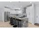 Modern kitchen features a large granite island with seating and stainless steel appliances at 12121 S 214Th Ave, Buckeye, AZ 85326