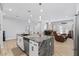 Eat-in kitchen features a large granite island and stainless steel appliances at 12121 S 214Th Ave, Buckeye, AZ 85326
