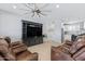 Open living room with leather seating and a view into the kitchen at 12121 S 214Th Ave, Buckeye, AZ 85326