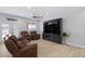 Spacious living room with leather furniture and a large flat-screen TV at 12121 S 214Th Ave, Buckeye, AZ 85326