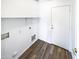 Laundry room with wood-look flooring and built in shelving at 1213 W Darrel Rd, Phoenix, AZ 85041