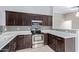 Updated kitchen with dark wood cabinets and stylish backsplash at 14829 N 41St Pl, Phoenix, AZ 85032