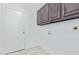 Bright laundry room with built-in cabinets and tile floor at 14829 N 41St Pl, Phoenix, AZ 85032