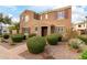 Two-story house with brown exterior, red shutters, and landscaped front yard at 1646 S Martingale Rd, Gilbert, AZ 85295