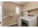 Laundry room with shelving, washer, and dryer at 1646 S Martingale Rd, Gilbert, AZ 85295