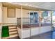 Covered patio with wooden steps, storage and wrought iron railing at 17200 W Bell Rd # 64, Surprise, AZ 85374