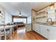 Bright kitchen with white cabinets, hardwood floors, and a view into the living area at 17200 W Bell Rd # 64, Surprise, AZ 85374