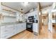 White cabinets, granite counters, and black appliances in a galley kitchen at 17200 W Bell Rd # 64, Surprise, AZ 85374