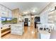 Open living space with L-shaped sofa, kitchen, and wood floors at 17200 W Bell Rd # 64, Surprise, AZ 85374