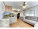 Open living space with L-shaped sofa, kitchen, and wood floors at 17200 W Bell Rd # 64, Surprise, AZ 85374