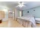 Main bedroom with king-size bed, ceiling fan and access to the bathroom and walk-in closet at 17200 W Bell Rd # 64, Surprise, AZ 85374