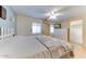 Main bedroom with king-size bed, ceiling fan, and access to closet and bathroom at 17200 W Bell Rd # 64, Surprise, AZ 85374