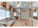 Room with a couch, built-in wooden cabinets and mirrored closet doors at 17200 W Bell Rd # 64, Surprise, AZ 85374