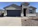 New gray stucco home with a two-car garage and desert landscaping at 18345 N San Juan St, Maricopa, AZ 85138