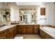 Elegant bathroom with double vanity, soaking tub, and walk-in shower at 19501 N 101St St, Scottsdale, AZ 85255