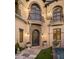 Elegant entryway with iron gate, arched doorway and balcony at 19501 N 101St St, Scottsdale, AZ 85255