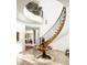 Impressive curved staircase with ornate railing and wood detailing at 19501 N 101St St, Scottsdale, AZ 85255