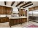 Island kitchen with granite countertops, stainless steel appliances and wood beams at 19501 N 101St St, Scottsdale, AZ 85255