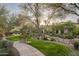 Landscaped pathway with a bench and trees at 19501 N 101St St, Scottsdale, AZ 85255
