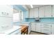 Kitchen with light blue cabinets and built-in desk at 250 Beryl Dr, Apache Junction, AZ 85119