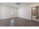 Spacious bedroom with wood-look floors and an ensuite bathroom with a bathtub at 26611 S 187Th Ave, Buckeye, AZ 85326