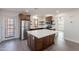 Modern kitchen with island and dark wood cabinets at 26611 S 187Th Ave, Buckeye, AZ 85326