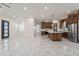 Open concept kitchen with dark wood cabinets and island at 26611 S 187Th Ave, Buckeye, AZ 85326