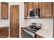 Modern kitchen with stainless steel appliances and dark wood cabinets at 26623 S 187Th Ave, Buckeye, AZ 85326