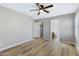 Bright bedroom with wood floors, ceiling fan, and en-suite bathroom access at 3124 W Pollack St, Phoenix, AZ 85041