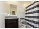 Bathroom with granite vanity and striped shower curtain at 3372 W Stanton Ave, Apache Junction, AZ 85120