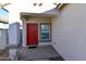 Covered entryway with red front door and single window at 3372 W Stanton Ave, Apache Junction, AZ 85120