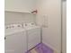 Bright laundry room with washer, dryer, and shelving at 3372 W Stanton Ave, Apache Junction, AZ 85120