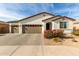 Single-story home with two-car garage and landscaped front yard at 3908 S 78Th Ln, Phoenix, AZ 85043