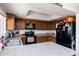 Modern kitchen featuring dark wood cabinets and black appliances at 3953 W Evans Dr, Phoenix, AZ 85053