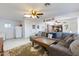 Living room with sectional sofa, open floor plan, and kitchen view at 3953 W Evans Dr, Phoenix, AZ 85053
