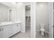 Bathroom with double vanity, toilet and walk-in closet at 4923 E Village Dr, Scottsdale, AZ 85254