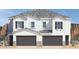 Two-story stucco home with dark gray garage doors and mountain views at 4923 E Village Dr, Scottsdale, AZ 85254